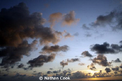 Sunset clouds over the water in Cozumel Mexico. by Nathan Cook 
